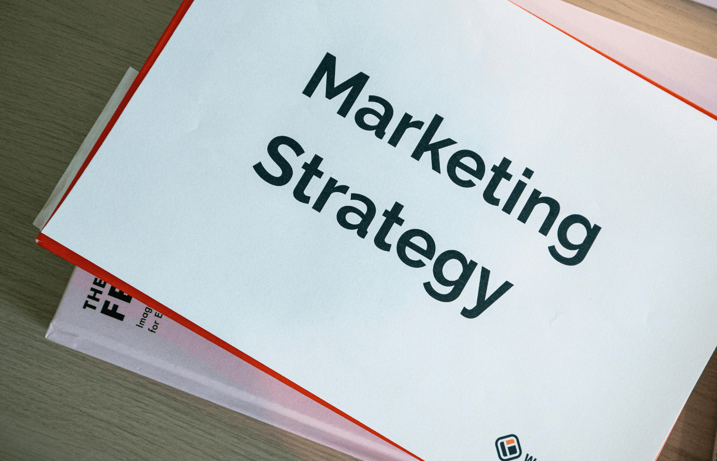 Close-up of a white book titled Marketing Strategy with a thin red border.